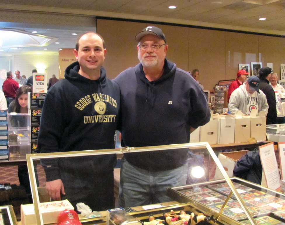 SUPER SPORTS HEROES: Mike Miller, who owns and operates Sports Heroes, a sports card and memorabilia store at 661 Oaklawn Avenue, is joined by his son at the show in West Warwick.