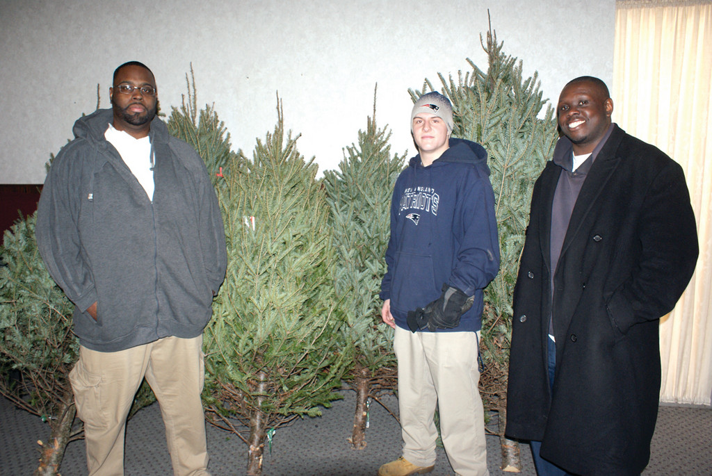 SPECIAL DELIVERY: Pictured are Praise Tabernacle Men’s Ministry Leader Dan Bullock, Thomas Cottam of Confreda Farms & Greenhouses and parishioner Gerald Price. Confreda Farms & Greenhouses donated six Christmas trees for the festivities during the Home-4-Homeless Holiday Dinner.