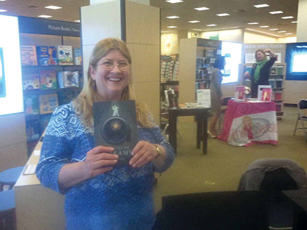 BOOK SIGNING: Cranston resident Dr. Karen Petit, a professor at CCRI and coordinator of the Writing Center there, signs copies of her debut novel, “Banking on Dreams” at a signing event at Barnes & Noble.