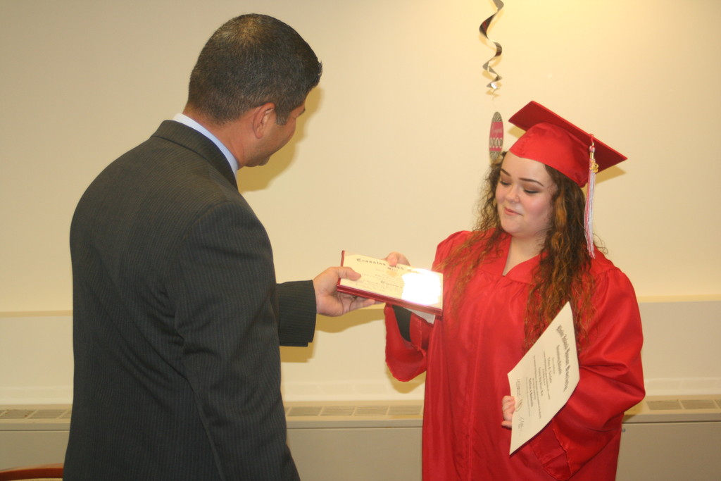 A DEFINING LIFE MOMENT: Tiffany receives her diploma from Principal Tom Barbieri, ending one chapter of her life and beginning another.
