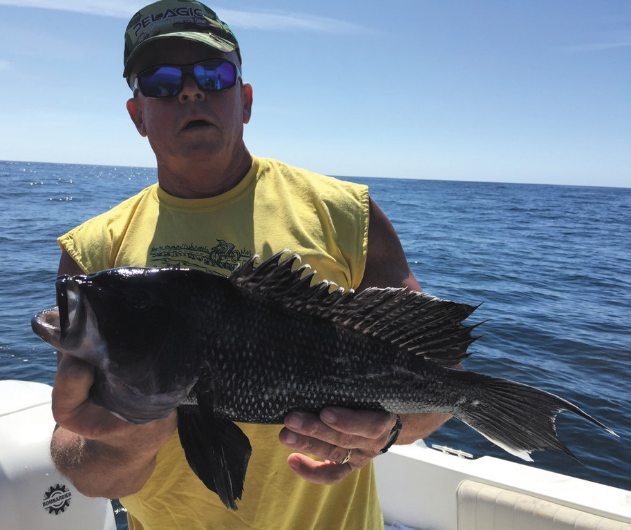 Jack Leyden of North Kingstown with a black sea bass he caught Monday with a weighted eel in 50 feet of water on the southwest ledge, Block Island.