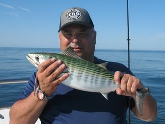Dave Henault of Ocean State Tackle with a bonito he caught Monday off the west wall of the Harbor of Refuge aboard On-the-Rocks Charters with Capt. Rene Letourneau.