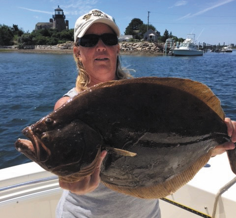 Gisele Golembeski with a mean looking 8 pound, 10 once summer flounder (fluke) she caught off Block Island Monday using one of her home made jigs tipped with squid and white fluke belly strip