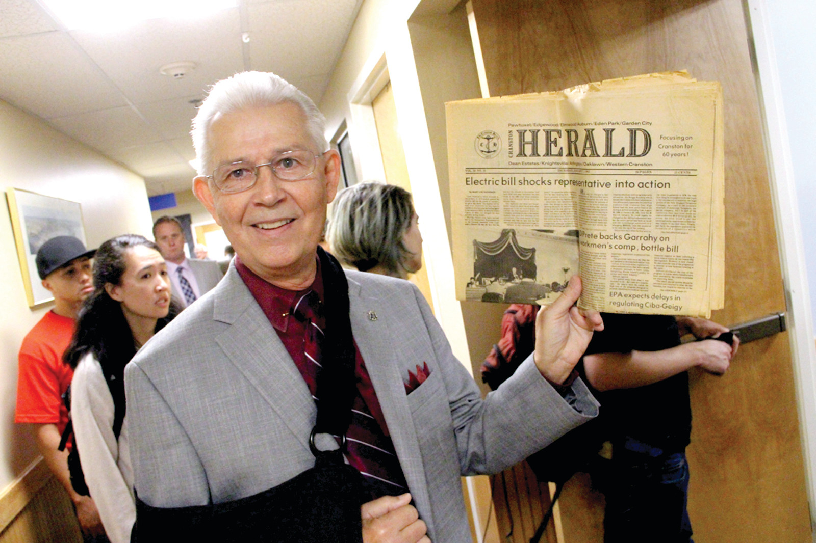 SAME STORY, DIFFERENT DAY: Rep. Robert Lancia holds a copy of Cranston Herald from the late 1970s with a lead page article about electric rate increases. “Things never change” was his message.
