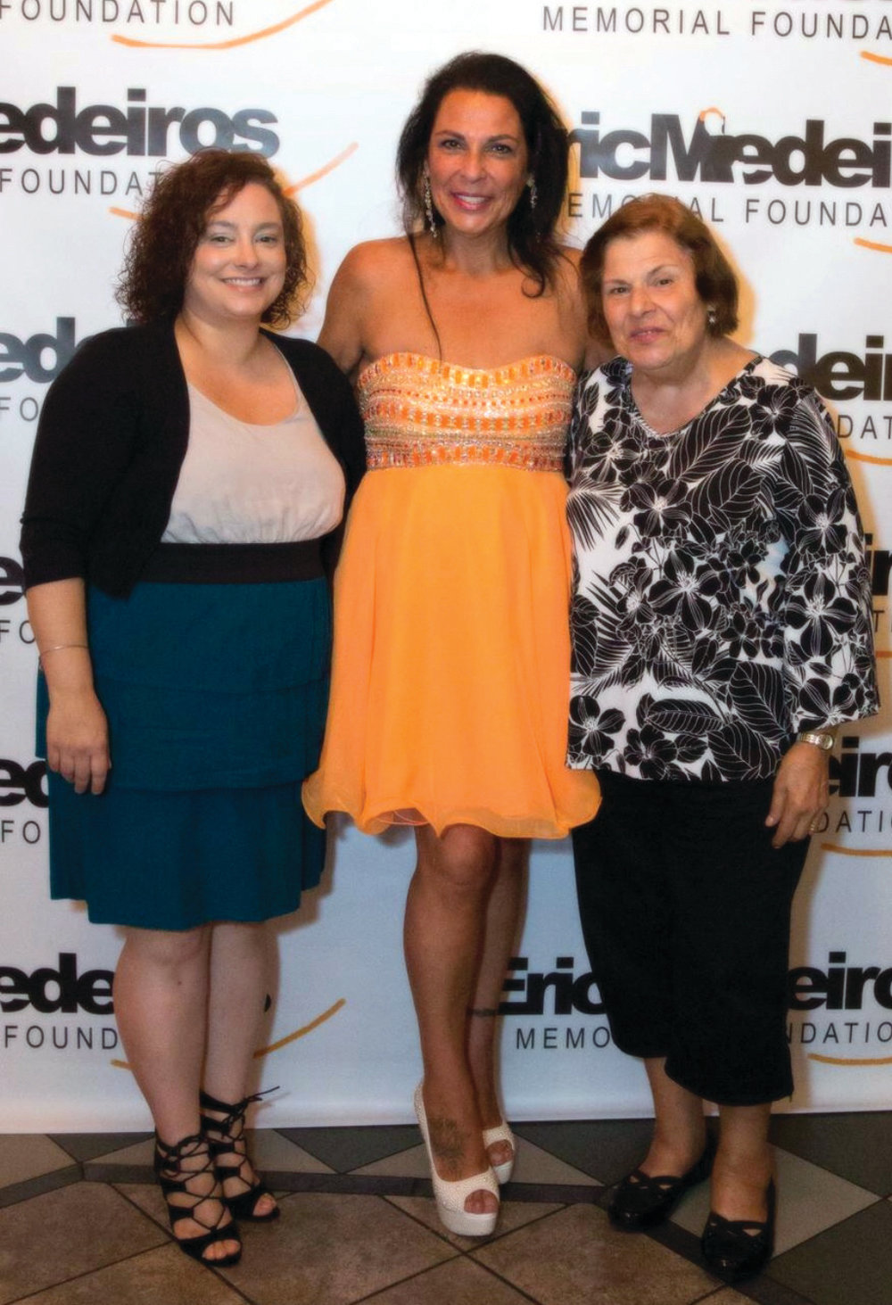 DOING GOOD: Anna Casador shares a moment with her daughter Jessica, left, and mother Esmeralda, right. The third annual Eric Medeiros Memorial Foundation Fundraising Gala will be held Sept. 3 at Spain Restaurant in Cranston.
