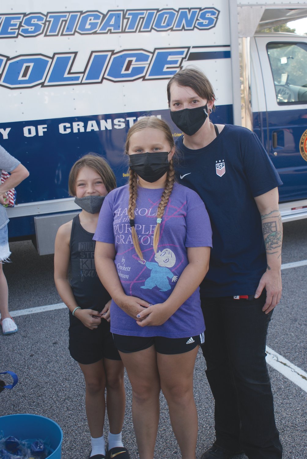 FAMILY MATTER: Learning more about the Cranston Police Department during the Garden City Summer Concert last week were Cambria Evans with her daughters Emma, age 9 and Sophia Ryan age 11
