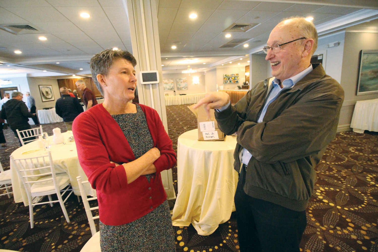 WHAT IT WAS LIKE: Judy Davis talks with Dennis Sleister, a member of the Warwick Rotary Club, following her talk describing her 3,804-mile trip across this country by bicycle.