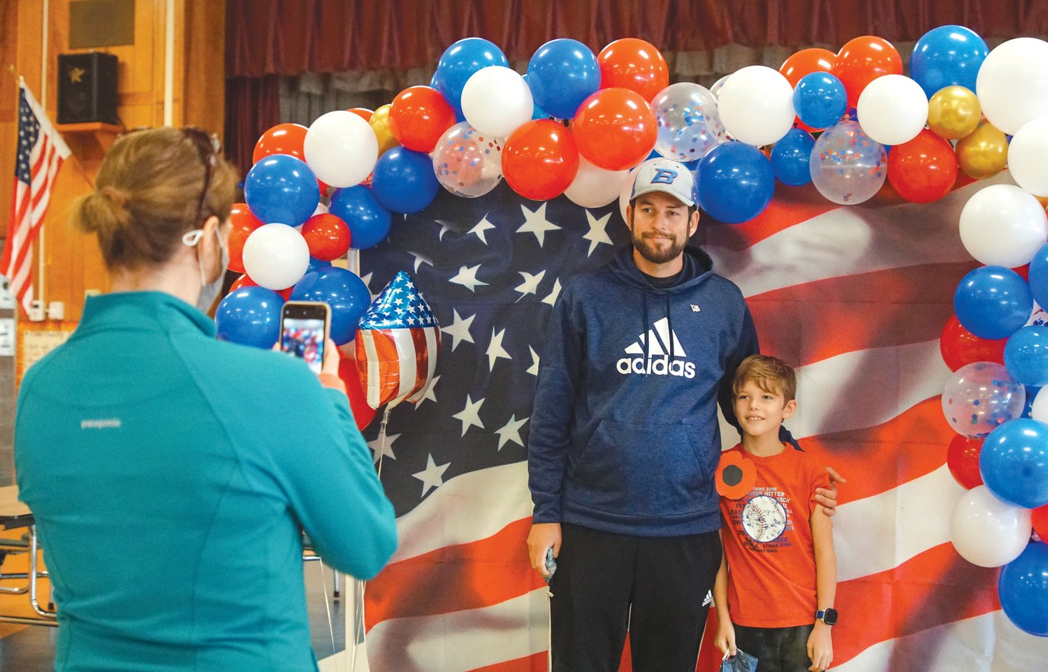 TO BE PATRIOTIC: Glen Hills student Lucca DuPree poses
in front of a patriotic backdrop with father Brad DuPree during
the school's Veterans Day Celebration on November 10