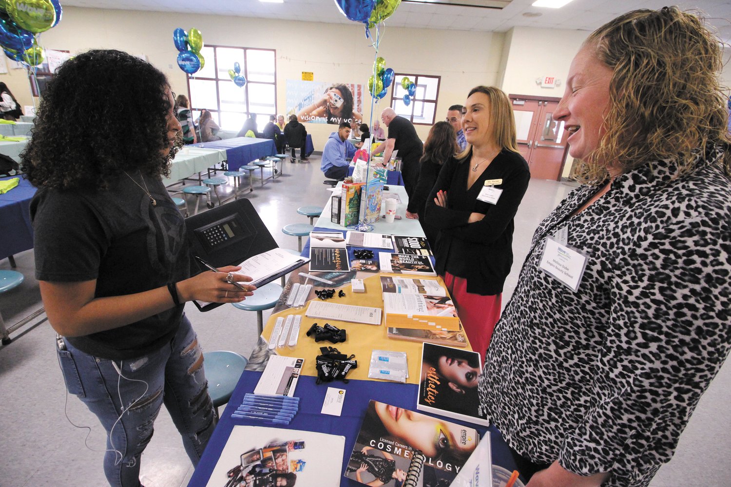 BUDGETING: Sarah Karim questions Melissa Dube and Renee Dubois from the Empire Beauty School on what she can expect to spend monthly on beauty supplies . Sarah would like to be a social worker and based on a projected income of $55,000 a year was watching her pennies at the Financial Education Fair. (Warwick Beacon photos)