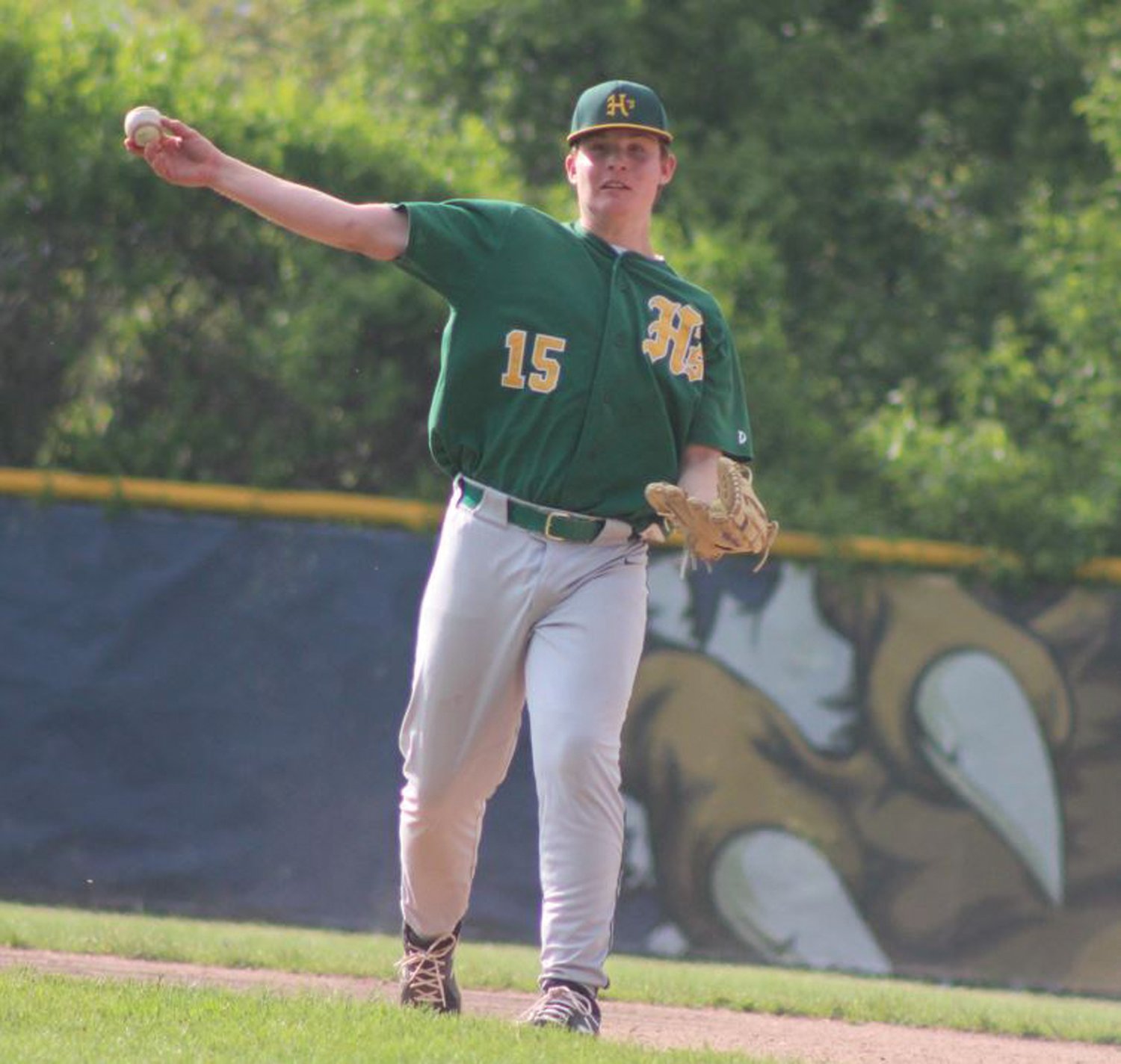 THE THROW TO FIRST: Hendricken’s Jeff Mercedes makes a play to first base.