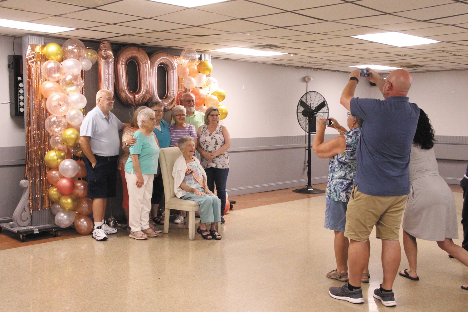ONE OF MANY GROUP SHOTS: Betty’s daughter Dianne Dunsmore sets up a group photo with her mother.