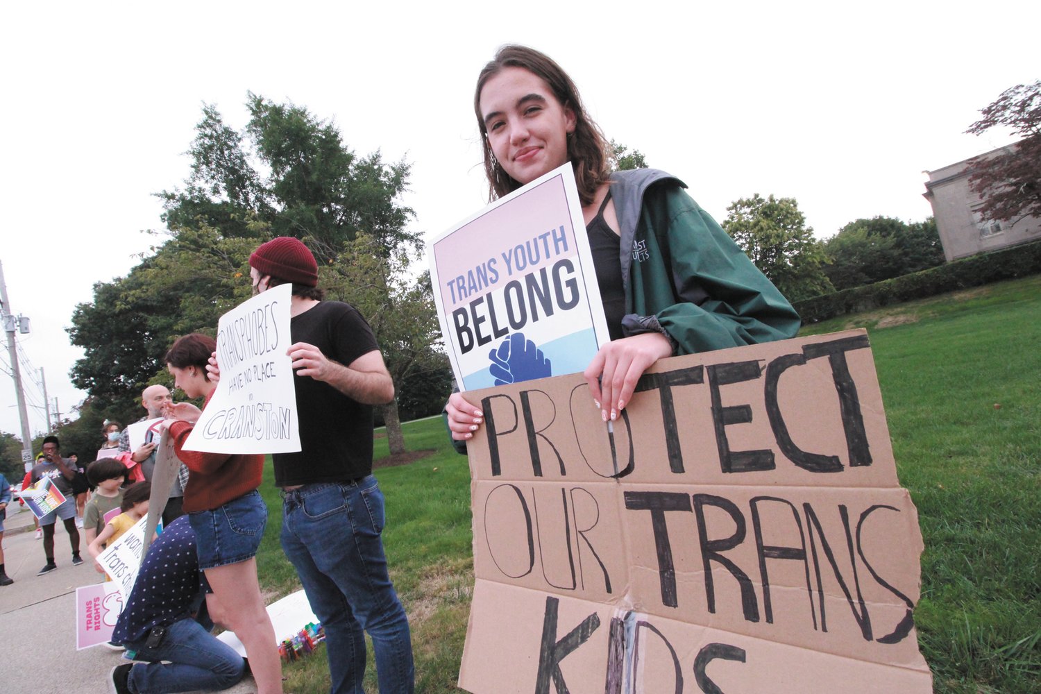 JOINING THE PHALANX: Arianna Cunha of Cranston was among the protesters of all ages to gather outside the William Hall Library Monday evening.