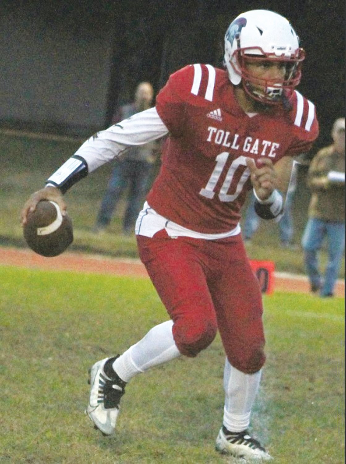 ON THE RUN: Toll Gate quarterback Jay Vann looks to pick up some yards.