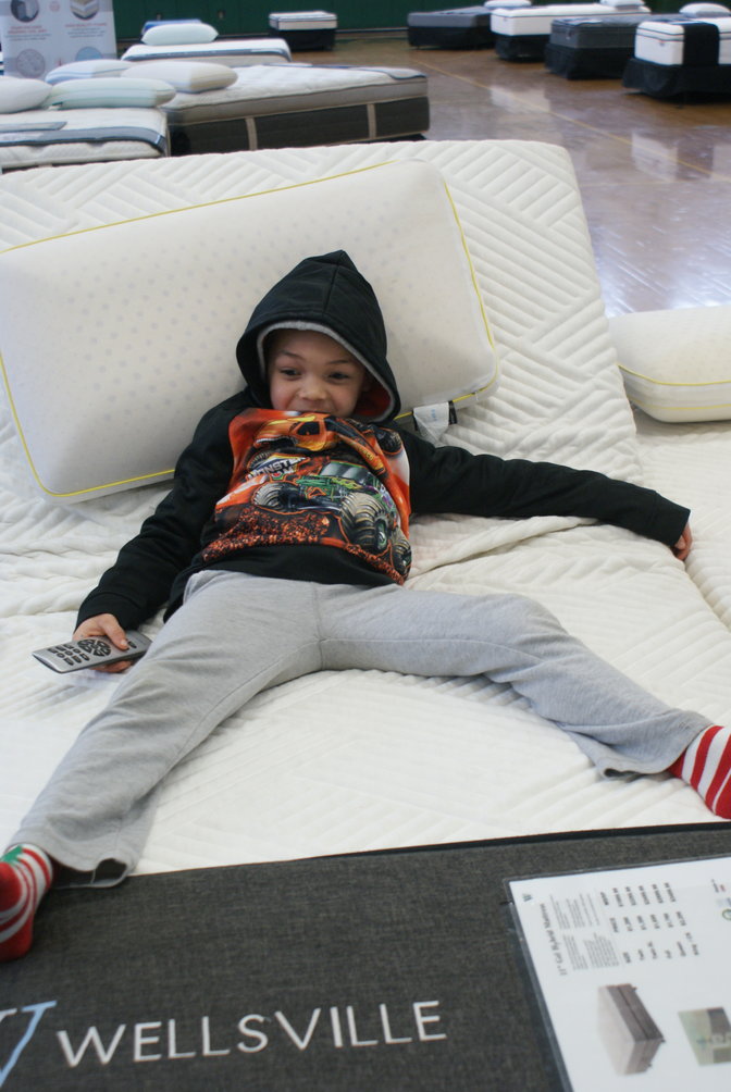 Just Relaxing:  6 year old Joseph Davenport was very relaxed as he tried out the adjustable bed while his mother was purchasing  two  mattresses at the Cranston’s Combined Percussion fund raiser at the Cranston East gym.