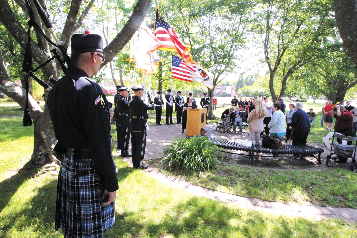 REFLECTIVE CEREMONY: The music of a bagpiper lent solemnity to the Memorial Day observance held Monday at Veterans Park on the grounds of Veterans Middle School. (Warwick Beacon photos)