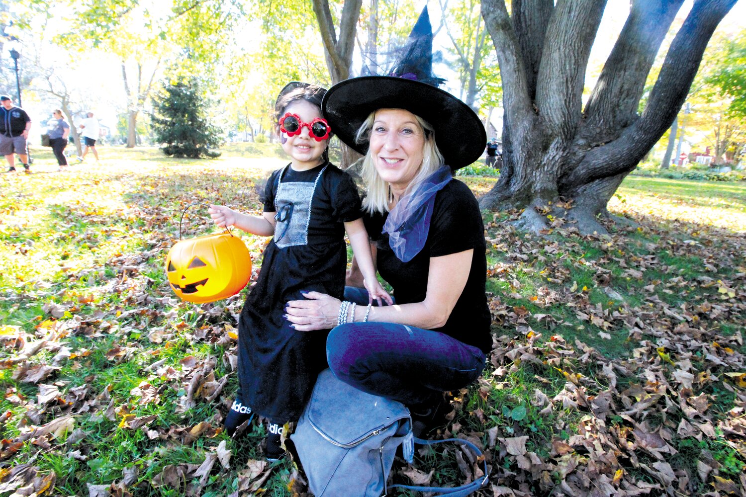 A WITCH'S DELIGHT: Rose Wojtanowski and her granddaughter Catalia Rodrigues find a leafy spot as they wait the start of the Pawtuxet Village parade